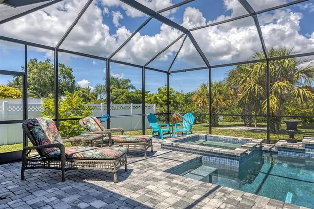 a living room with patio furniture and a potted plant