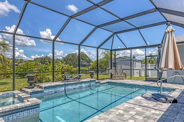 a swimming pool with patio outdoor seating and yard