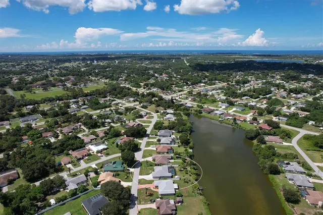 an aerial view of residential building and lake