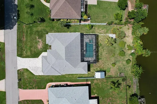 an aerial view of a house with a yard