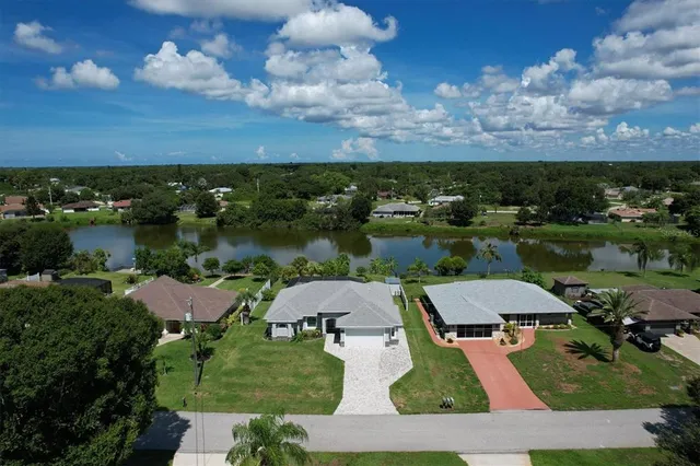 an aerial view of a house with a lake view