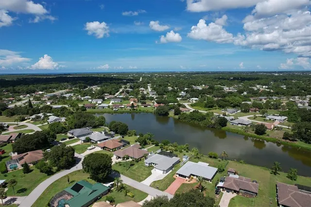 an aerial view of a house with a lake view