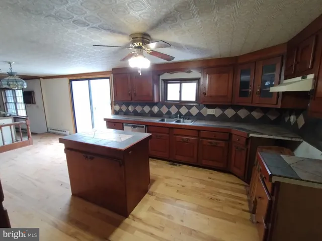 a view of a hallway with wooden floor and furniture