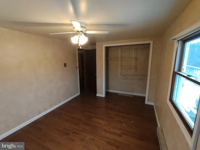 a view of a hallway with wooden shelves