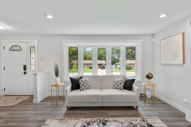 a living room with furniture and a large window