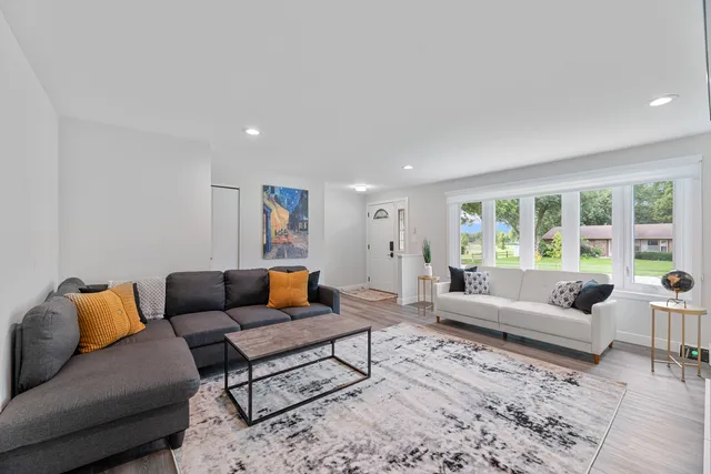 a living room with furniture and a large window