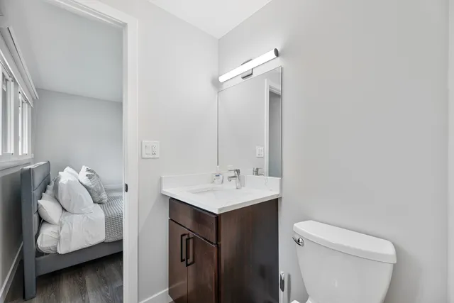 a bathroom with a sink toilet and mirror