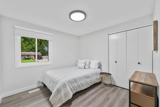 a bedroom with a bed and a window