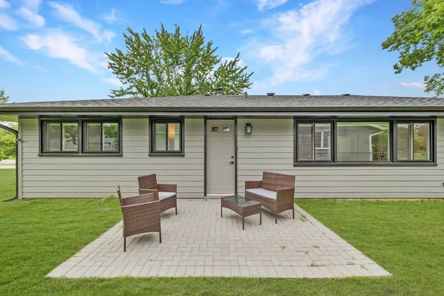 a swimming pool with outdoor seating and yard