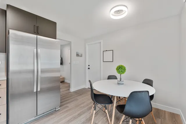 a dining room with furniture and wooden floor