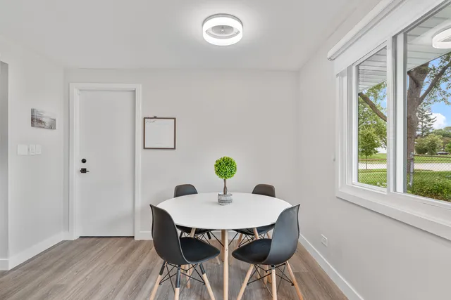 a dining room with furniture and window