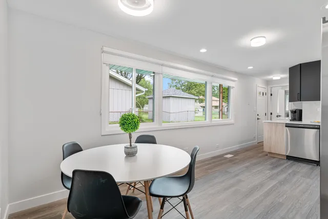 a view of a dining room with furniture window and wooden floor