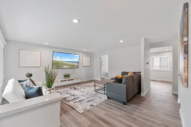 a living room with furniture and wooden floor