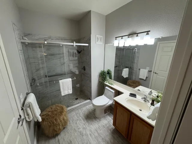a bathroom with a sink toilet and shower