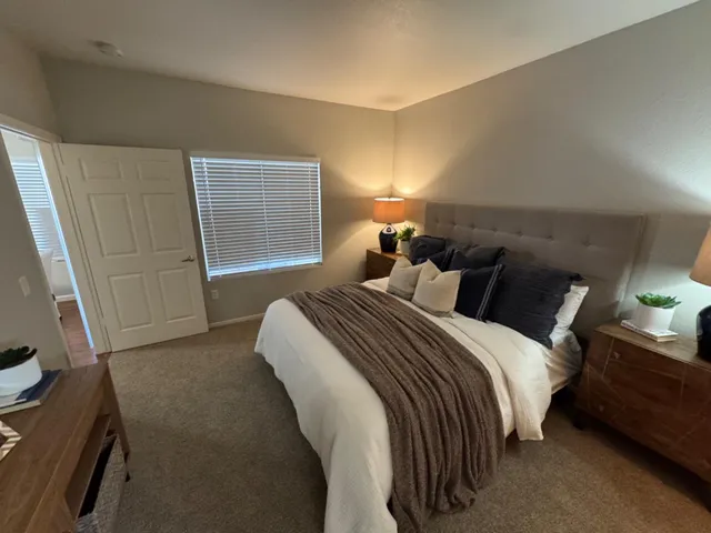 a bedroom with a bed and a window