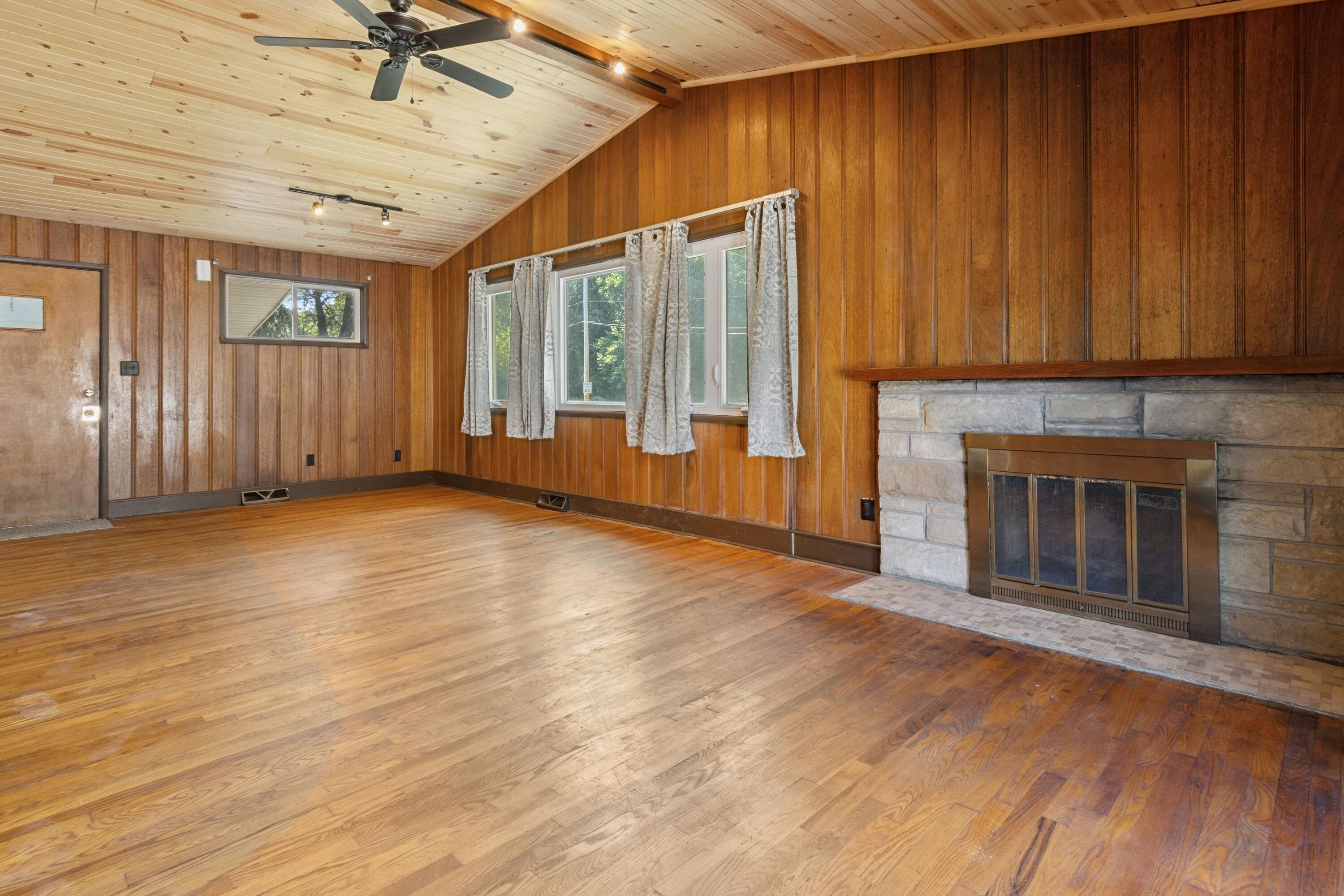 7800 Juniper Avenue Gary, IN 46403 - Photo 7 of 30 a view of an empty room with a window and wooden floor