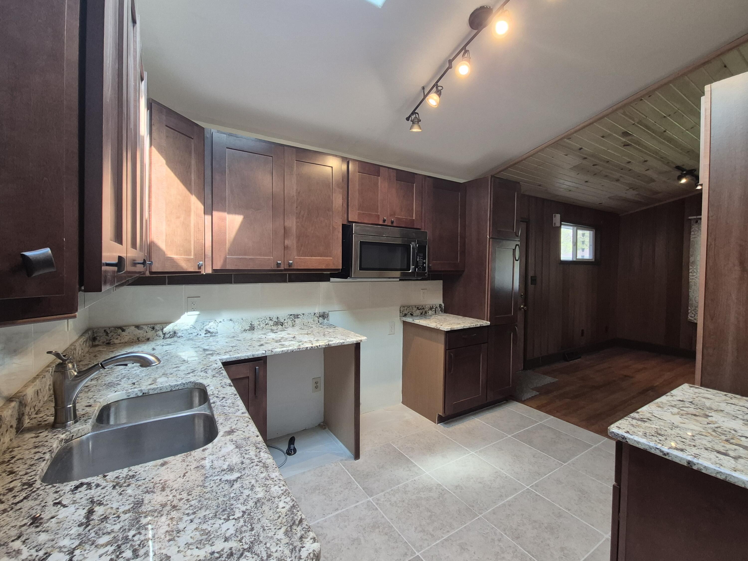 7800 Juniper Avenue Gary, IN 46403 - Photo 10 of 30 a kitchen with a sink stove and cabinets