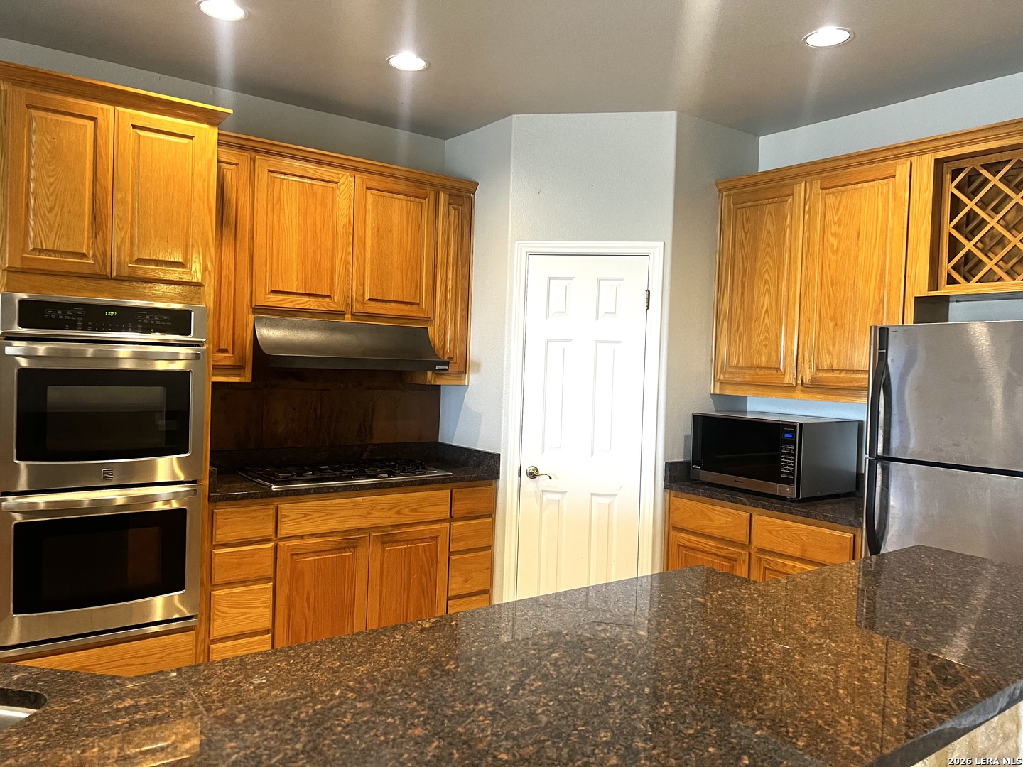 1816 Shepherds Bulverde, TX 78163 - Photo 12 of 32 a kitchen with stainless steel appliances a stove a sink and a refrigerator