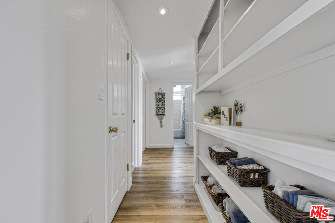 2735 Beth Place Simi Valley, CA 93065 - Photo 15 of 31 a hallway with white cabinets and black appliances