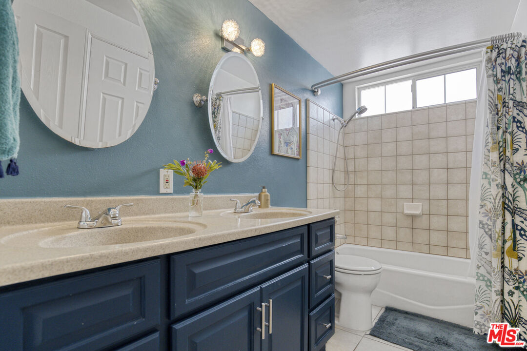 2735 Beth Place Simi Valley, CA 93065 - Photo 21 of 31 a bathroom with a toilet a sink a mirror a bathtub and a shower