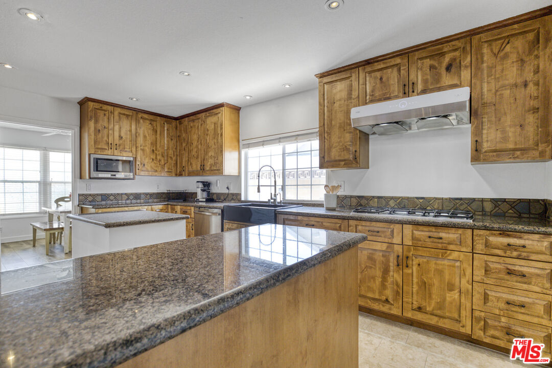 2735 Beth Place Simi Valley, CA 93065 - Photo 9 of 31 a kitchen with stainless steel appliances granite countertop a stove a sink and a microwave