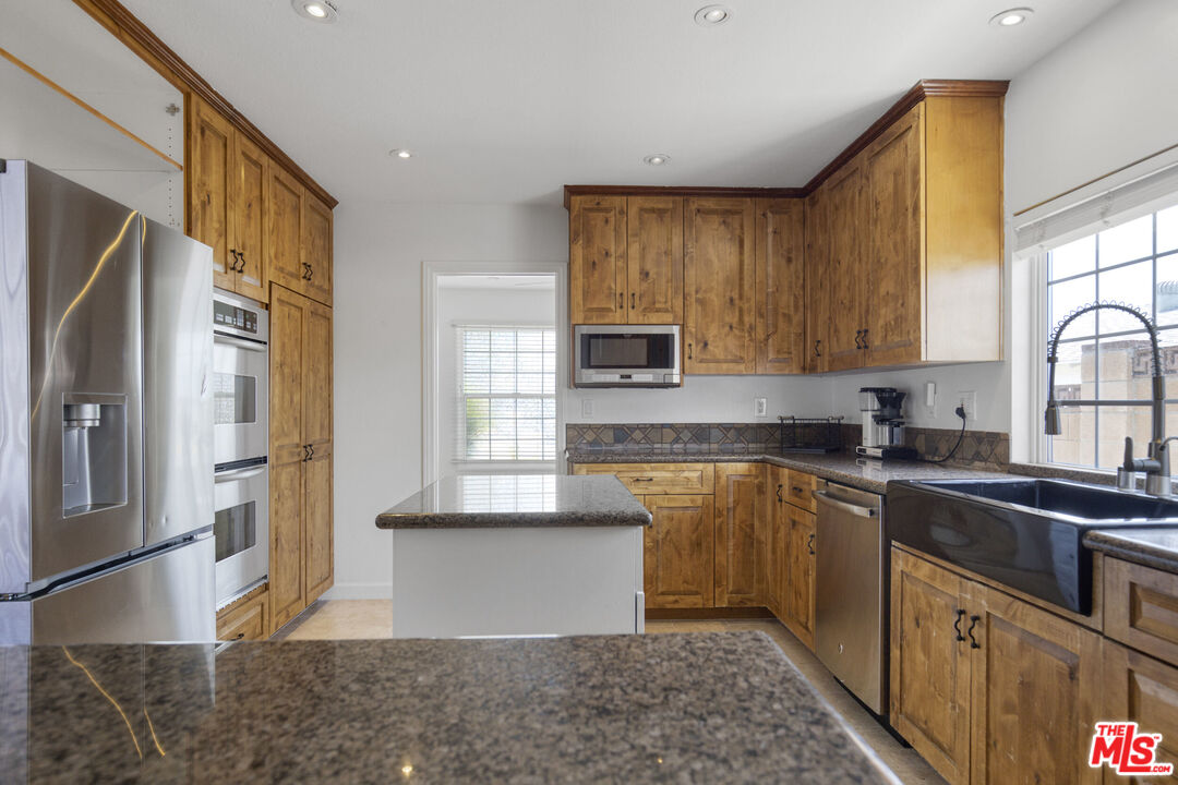 2735 Beth Place Simi Valley, CA 93065 - Photo 10 of 31 a kitchen with stainless steel appliances granite countertop a refrigerator sink and cabinets