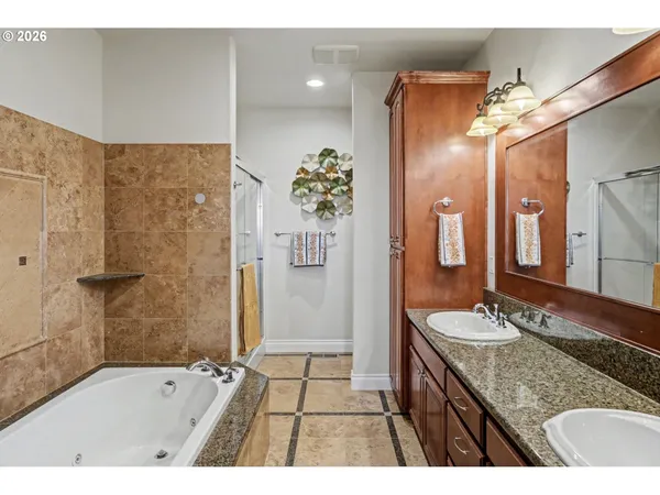 a bathroom with a granite countertop sink mirror and shower