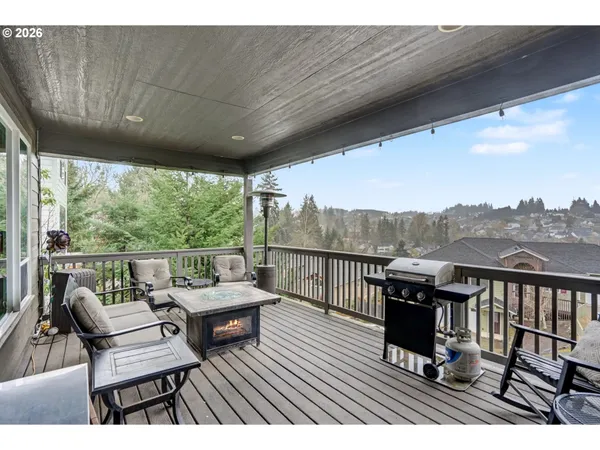 a view of a balcony with chairs and wooden floor