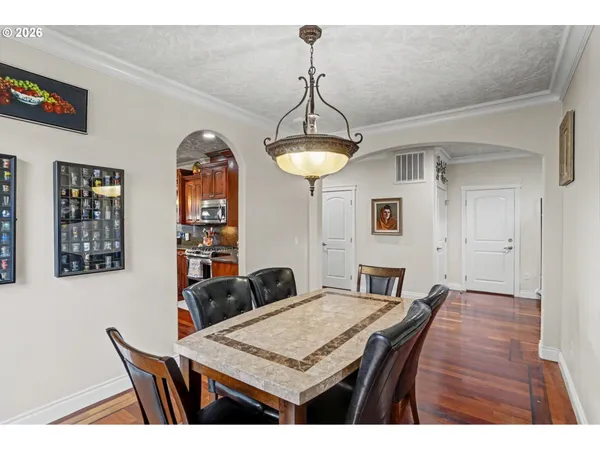 a view of a dining room with furniture and wooden floor