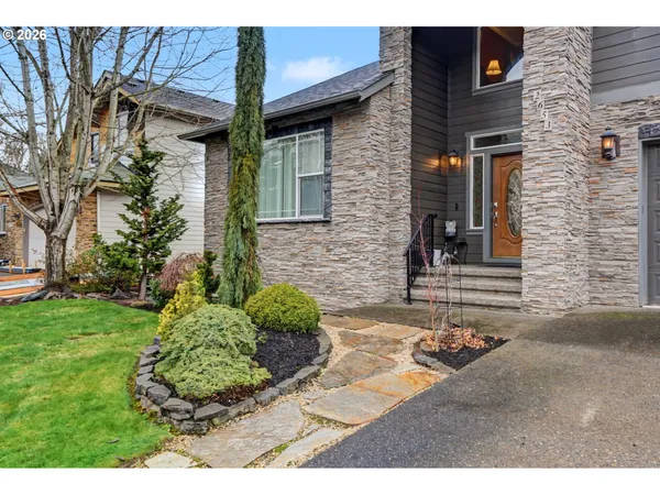 a view of a brick house with a yard