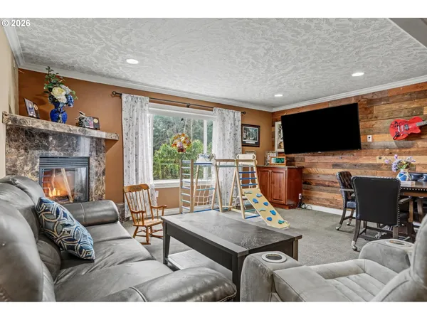 a living room with furniture a flat screen tv and a large window