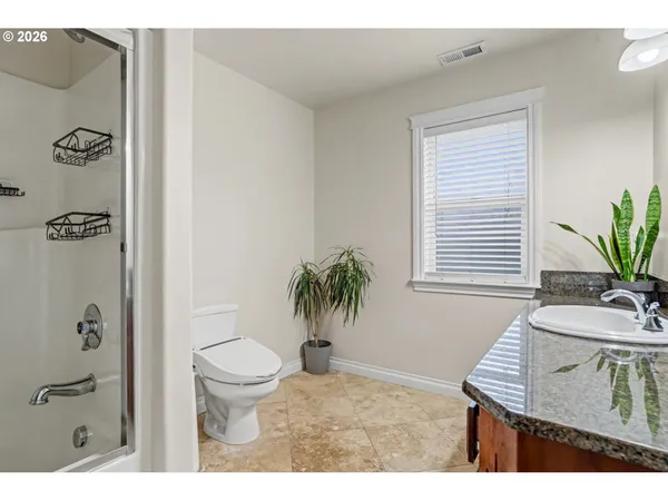 a bathroom with a toilet a sink and a mirror