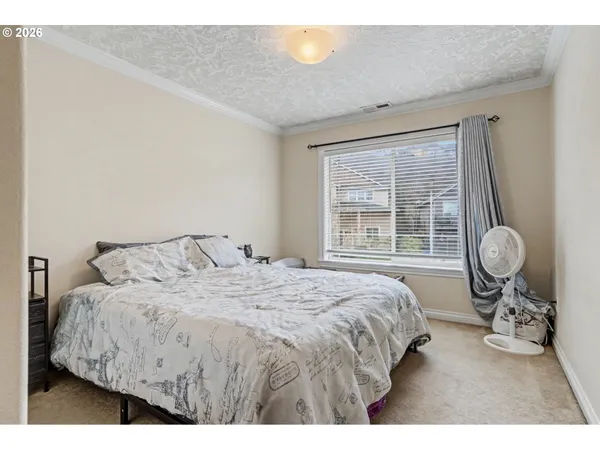 a bedroom with a bed and window