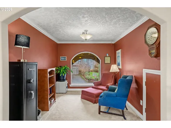 a living room with furniture a flat screen tv and a wall clock