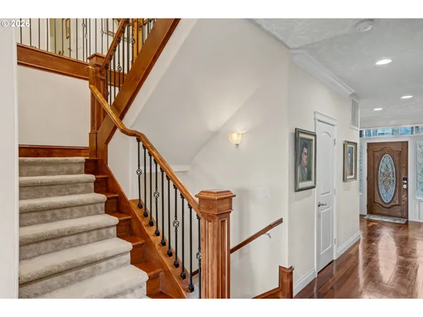 a view of entryway and hall with wooden floor