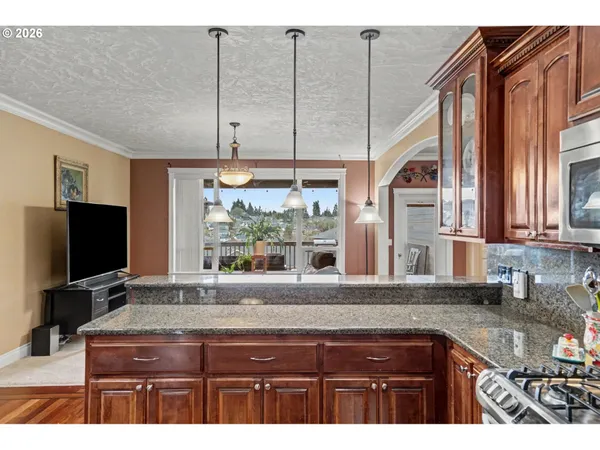 a kitchen view with a sink and large windows