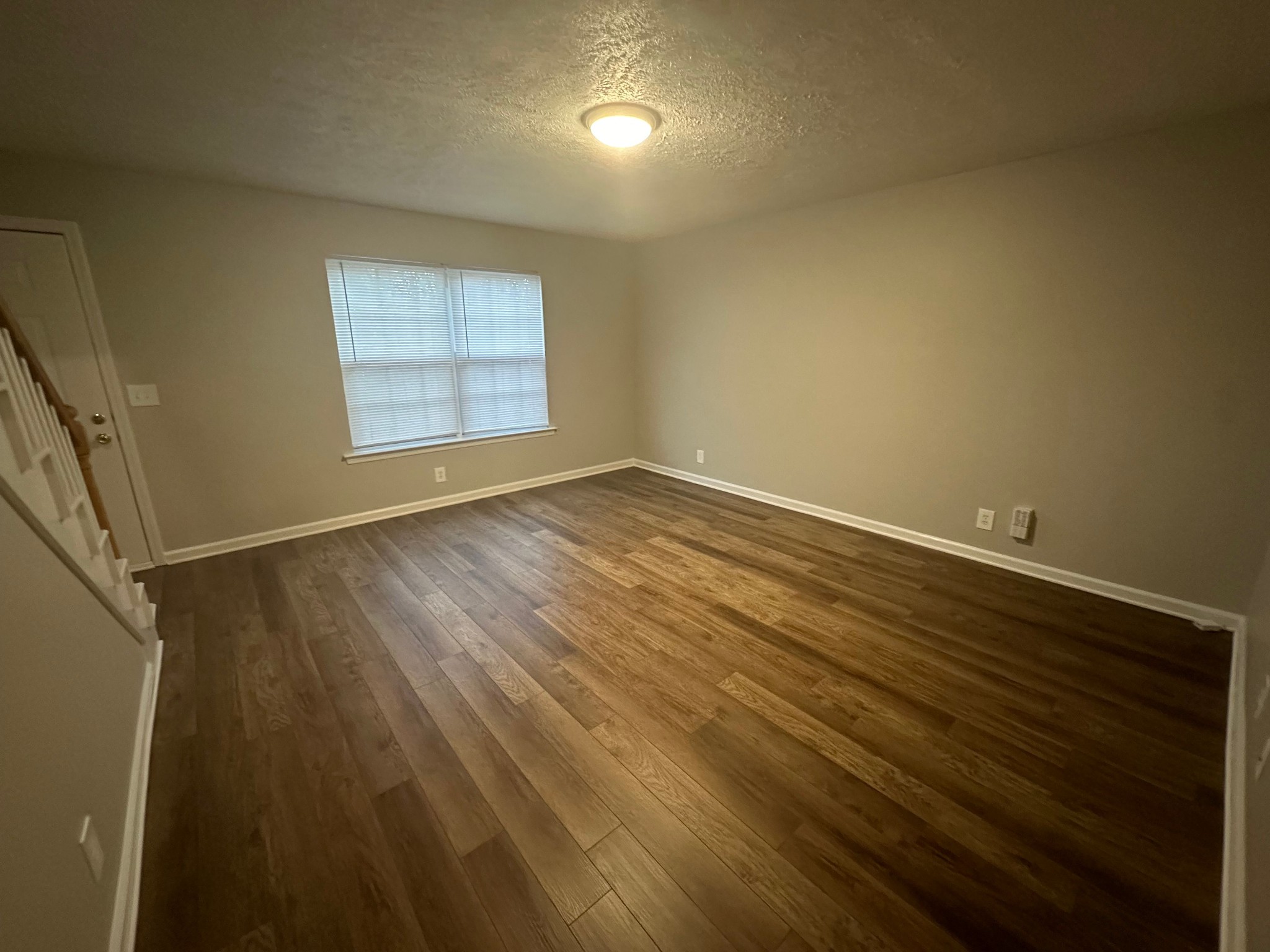 2434 Willowbrook Drive, Unit D Murfreesboro, TN 37130 - Photo 3 of 14 an empty room with wooden floor and windows