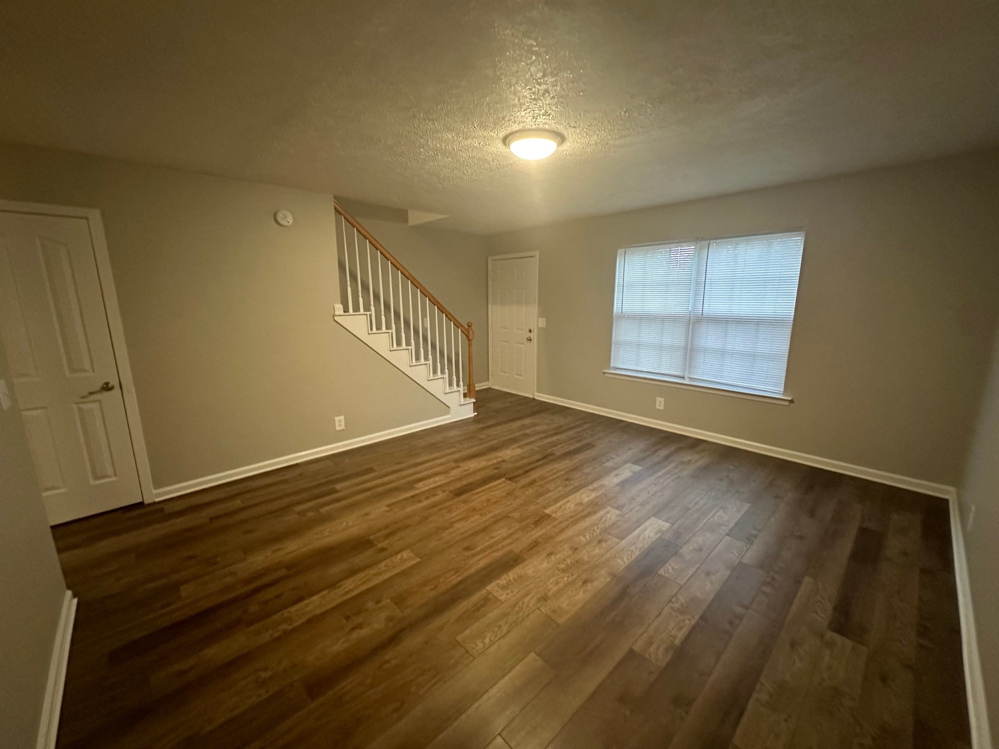 2434 Willowbrook Drive, Unit D Murfreesboro, TN 37130 - Photo 4 of 14 a view of an empty room with wooden floor and a window