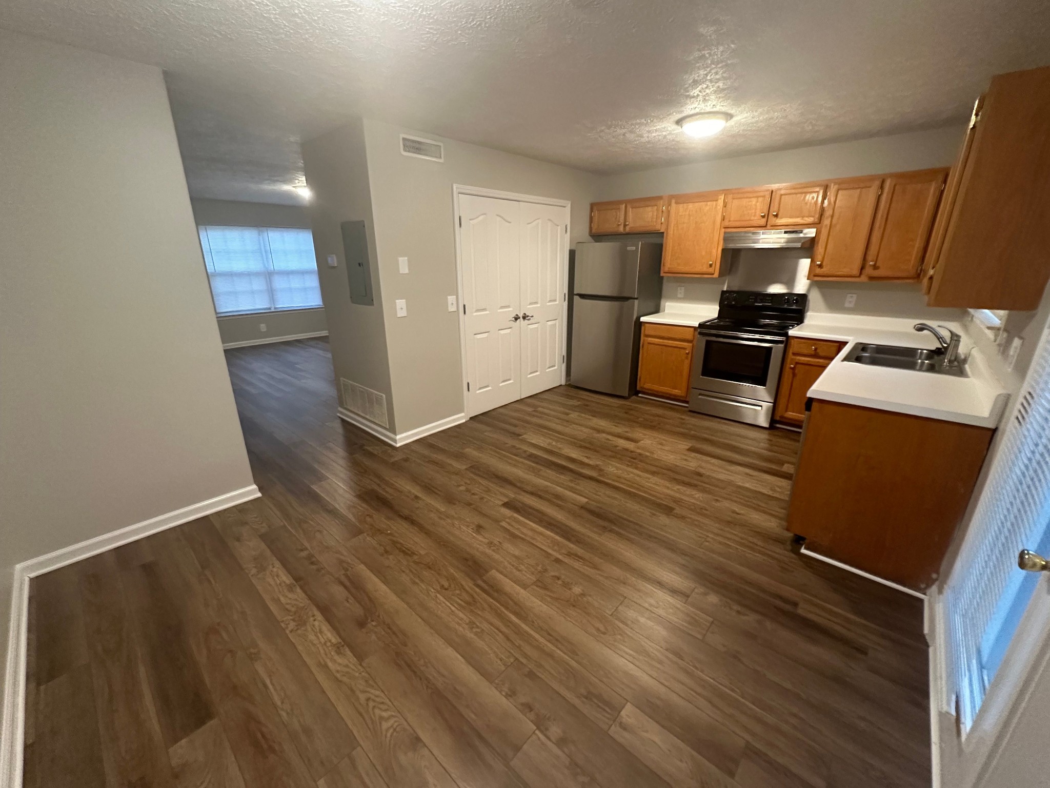 2434 Willowbrook Drive, Unit D Murfreesboro, TN 37130 - Photo 5 of 14 a kitchen with stainless steel appliances wooden floor and a refrigerator