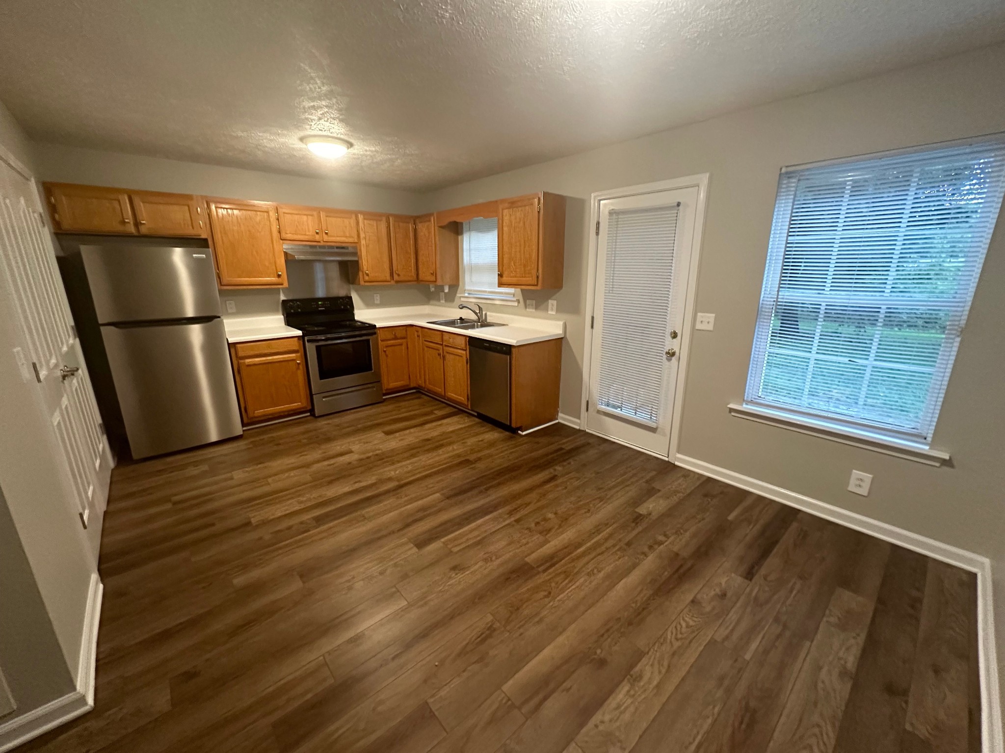 2434 Willowbrook Drive, Unit D Murfreesboro, TN 37130 - Photo 6 of 14 a kitchen with a refrigerator and wooden cabinets