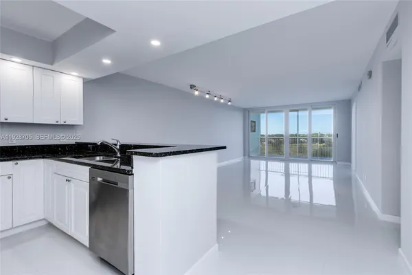 a kitchen with stainless steel appliances granite countertop a refrigerator and a stove