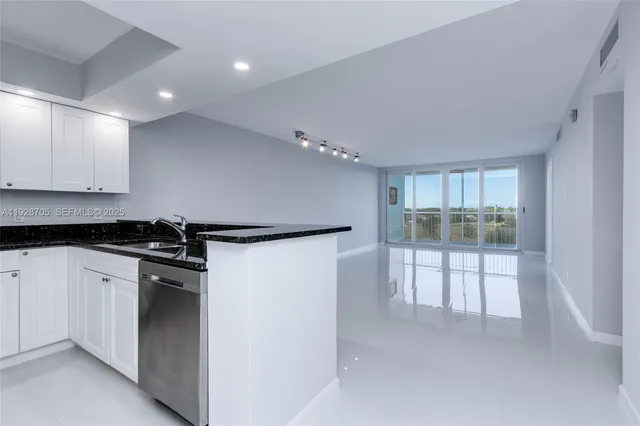 a kitchen with stainless steel appliances granite countertop a refrigerator and a stove