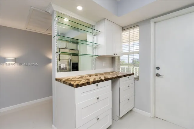 a kitchen with granite countertop a sink and a stove