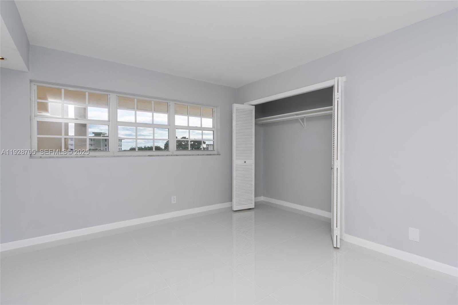 3090 North Course Drive, Unit 609 Pompano Beach, FL 33069 - Photo 18 of 36 an empty room with a window