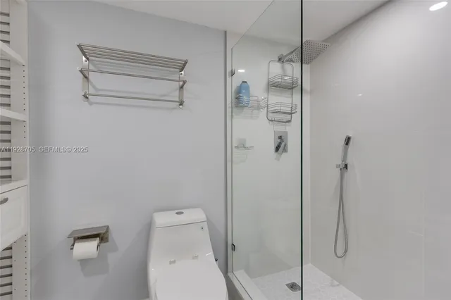 a bathroom with a shower and toilet