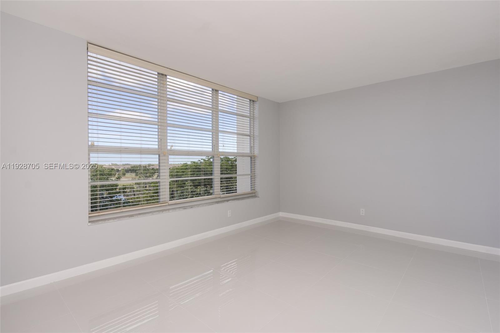 3090 North Course Drive, Unit 609 Pompano Beach, FL 33069 - Photo 22 of 36 a view of an empty room with a window