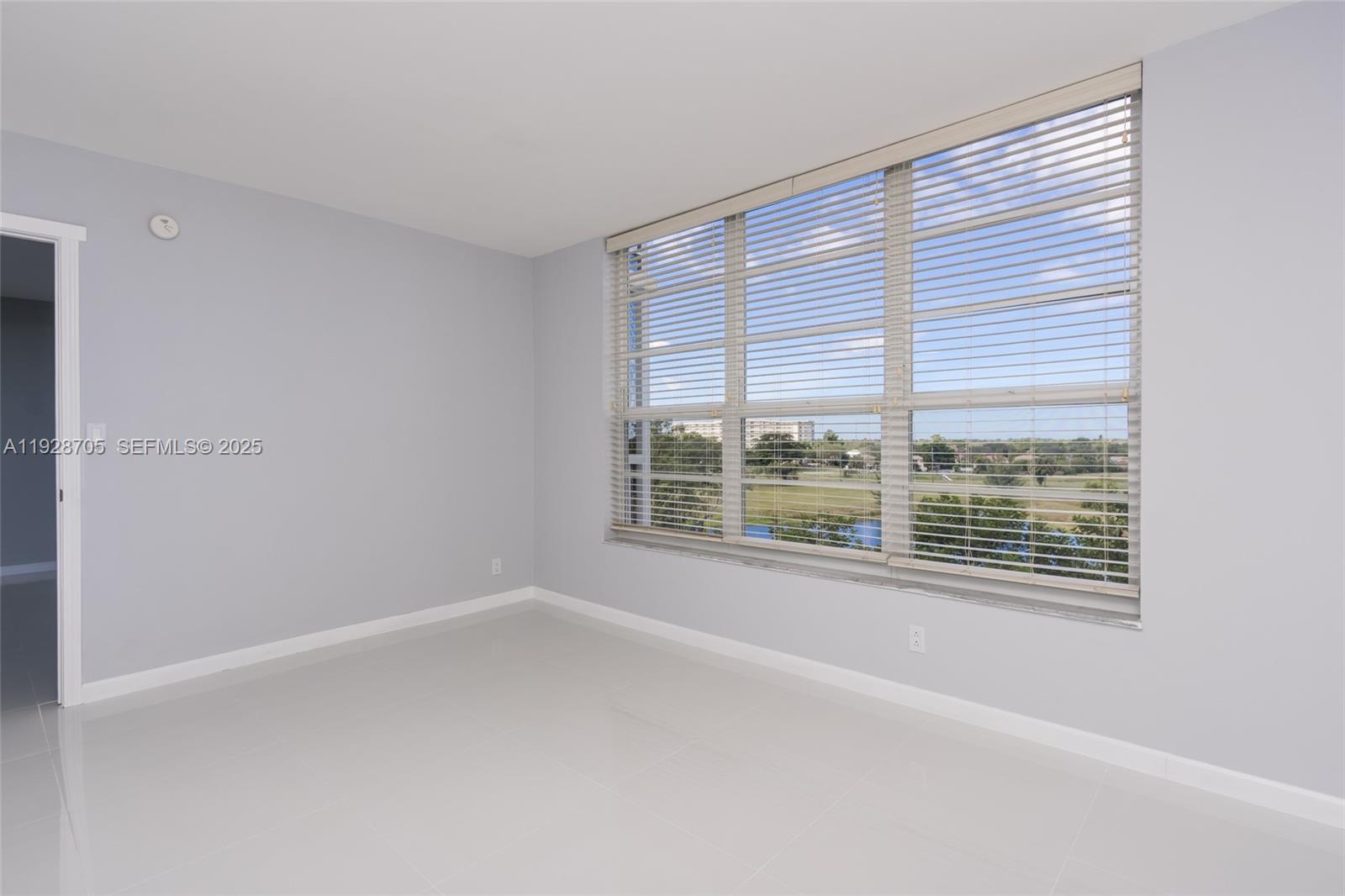 3090 North Course Drive, Unit 609 Pompano Beach, FL 33069 - Photo 23 of 36 a view of an empty room with a window