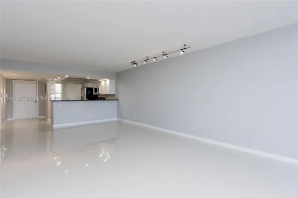 a view of a kitchen with white cabinets