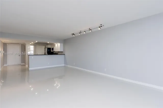 a view of a kitchen with white cabinets