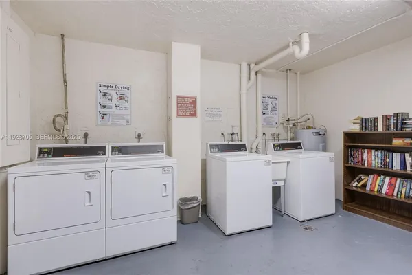 a room with cabinets dryer and washer